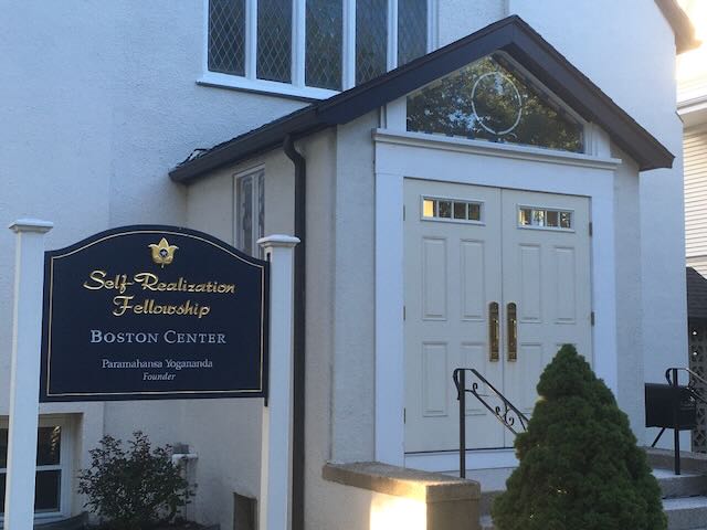 front door of white building with sign that reads Self-Realization Fellowship Boston Center